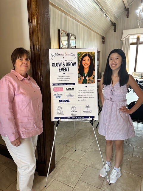Anna and Robin with the Glow and Grow event sign